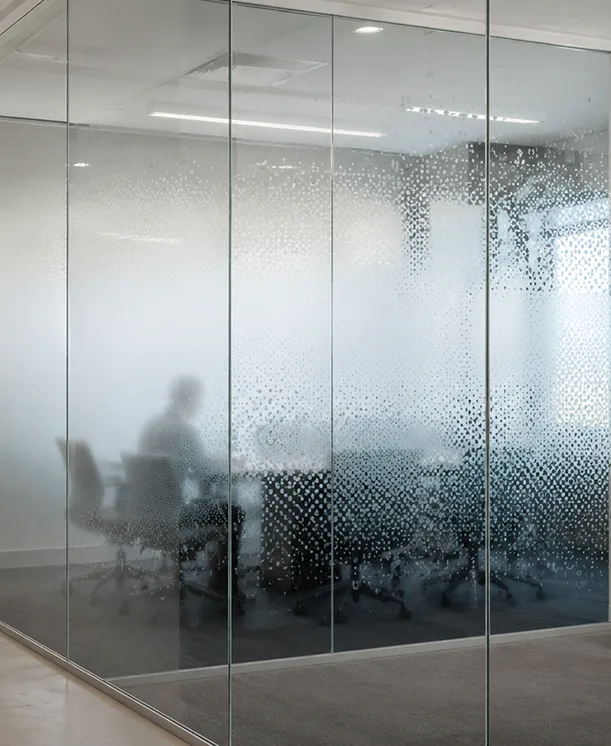 Office meeting room behind frosted glass partitions.